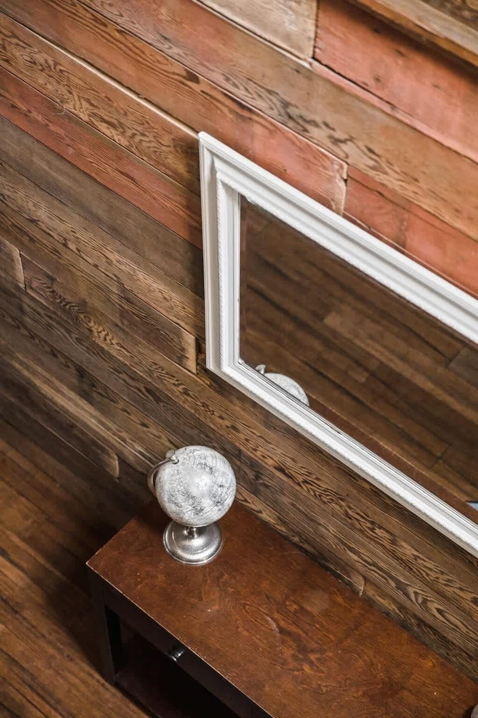 Take in the worldly charm of our decorative globe resting on a table, perfectly complemented by a mirror adorning the wall. Together, they add an air of elegance and intrigue to the space.