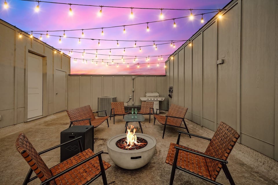 Stay nice and cozy warm as you chat all night long by the glow of this fire pit and under the twinkling string lights.