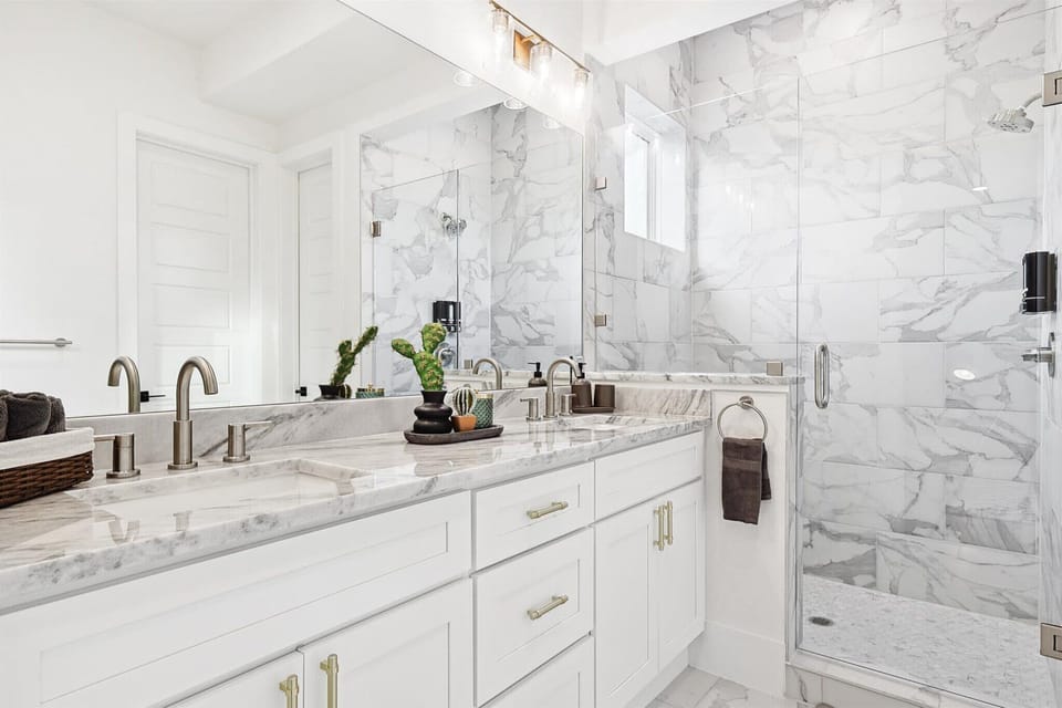 With stone counters, dual vanities, and a glass walk-in shower, this bathroom was designed to ensure you start and end every day just the way you want to!