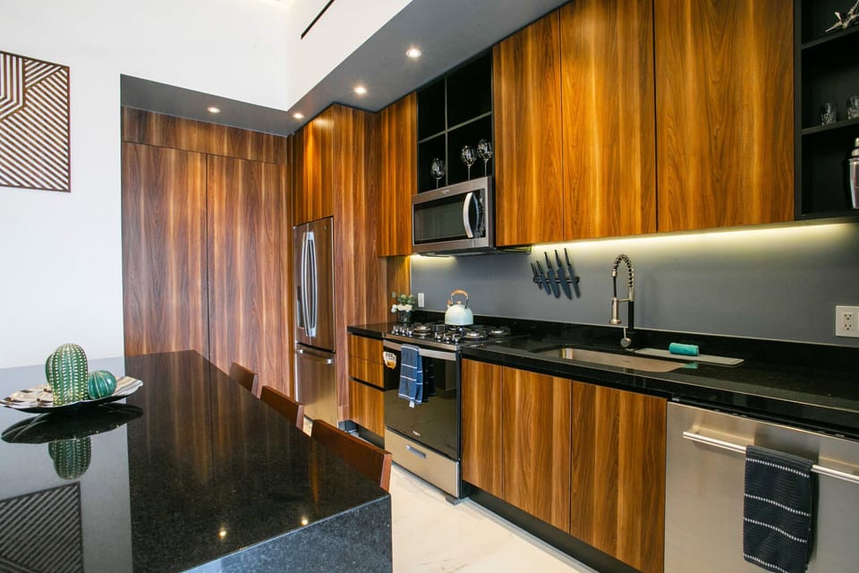The kitchen bar can be used as a dining table with seating for 6