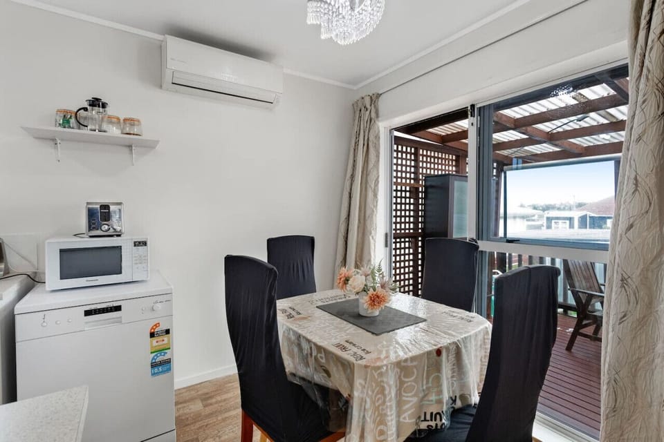 There is a heat pump/air-conditioner in the dining room area.