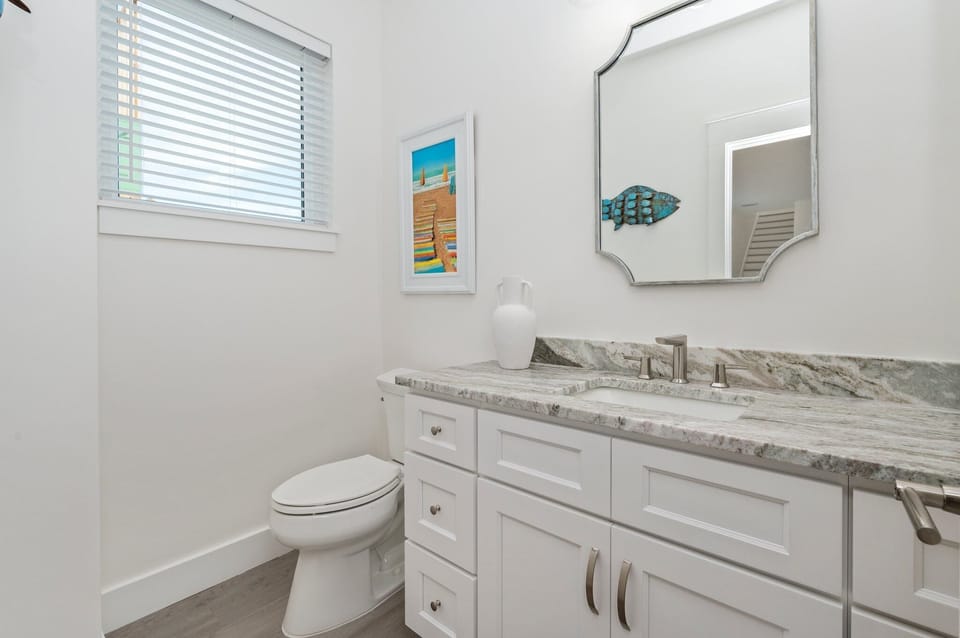 Convenient half bath located just off the kitchen.