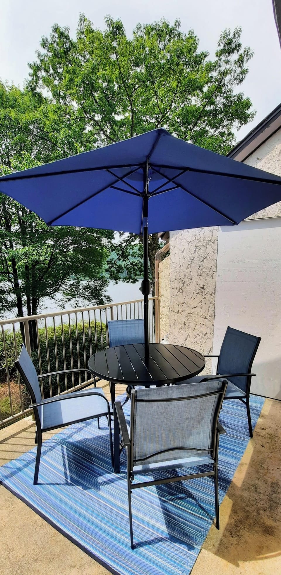 Balcony with new table and chairs, umbrella and gas grill