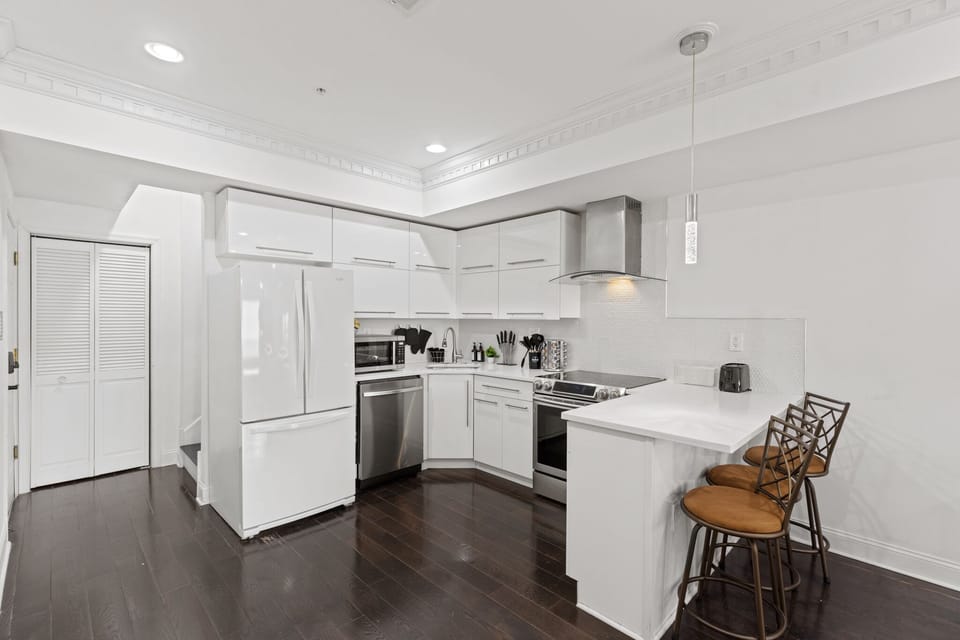 Embrace the joy of cooking in our fully stocked kitchen with bar stools