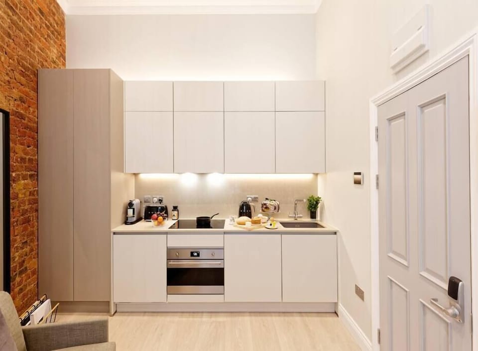 Fully equipped kitchen with oven-microwave, stove, washing machine & dryer, mini-fridge, kettle, toaster, coffee maker and kitchen utensils.