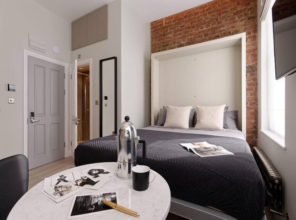 Living room area, with comfortable wall bed. Latest technology system, easy to use and space efficient to enjoy as much as possible your stay. The wall bed can be easily folded into a comfortable sofa for your commodity.