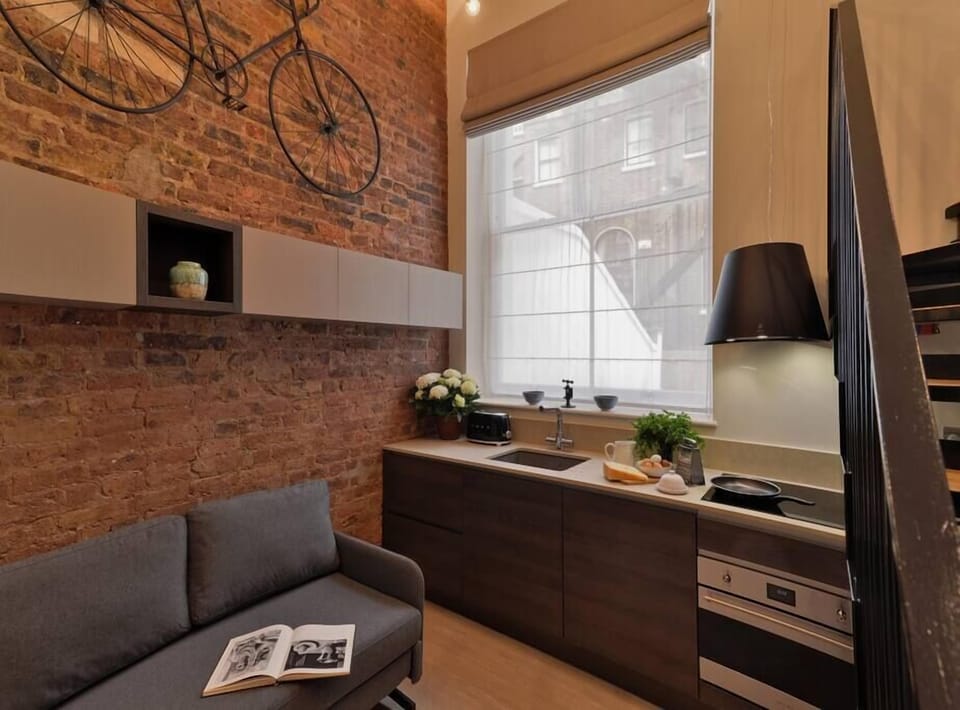 Open space with private kitchen area fully equipped with washing machine-dryer, oven-microwave, stove, kettle, toaster, Nespresso coffee machine, and kitchenware. Salt and pepper included. Non-included oils or food.