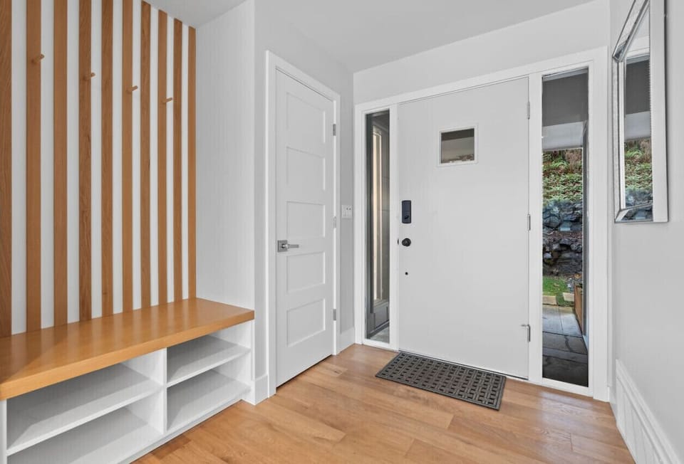 Entryway offers a coat closet and a bench!