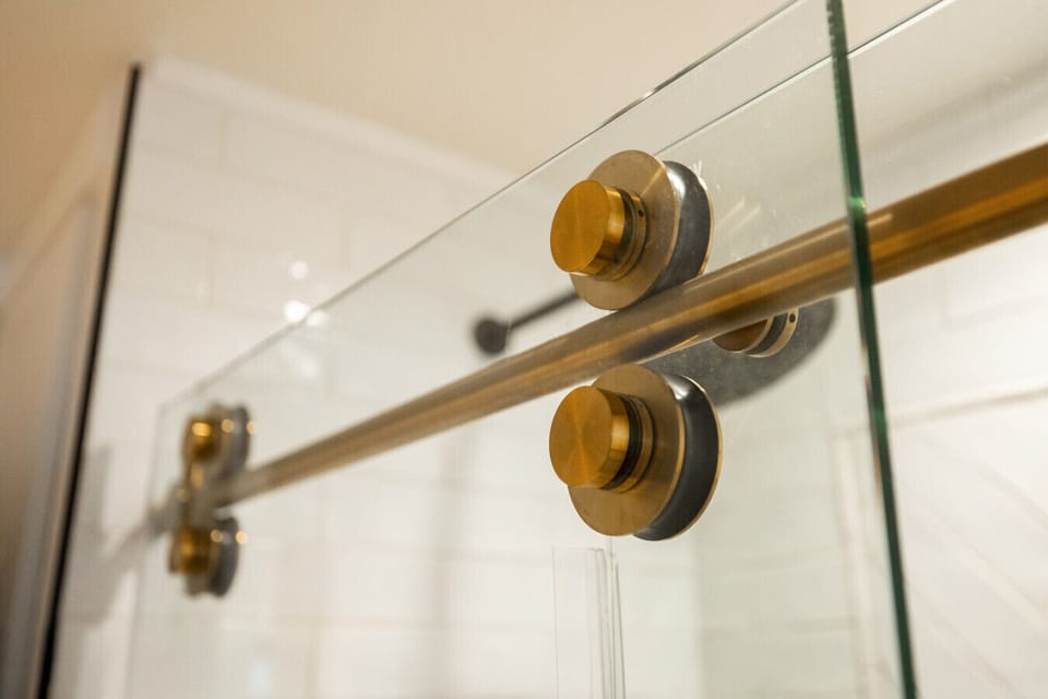 Detail view highlighting brushed-gold shower fittings.