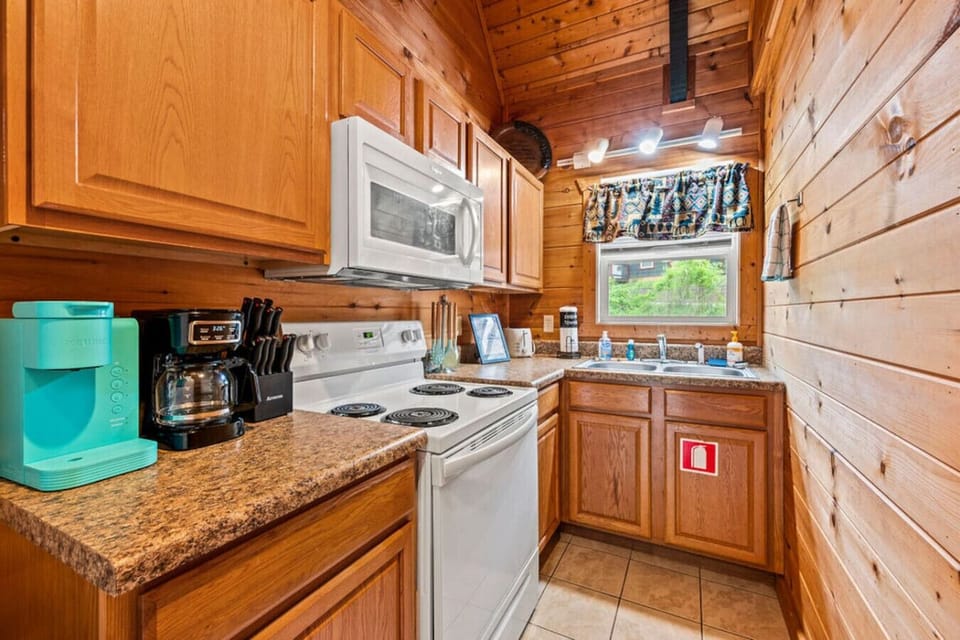 The kitchen includes a refrigerator, oven, microwave, appliances, and more.