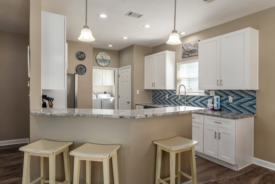 Your bright, open kitchen features granite counters, modern appliances, and a breakfast bar perfect for morning coffee conversations.