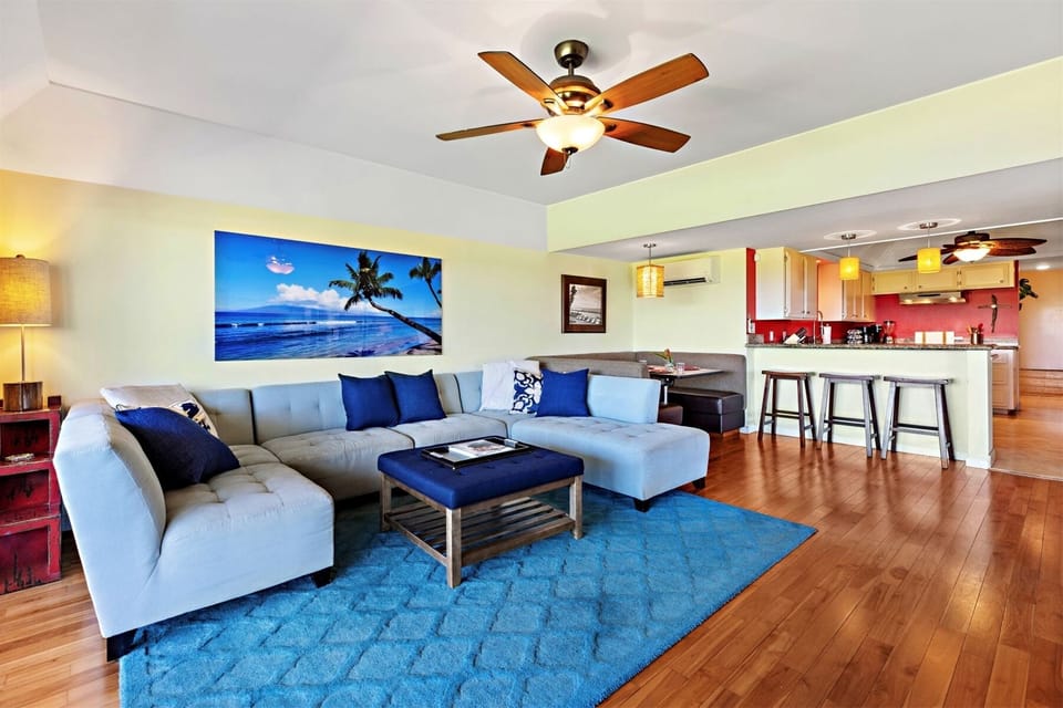 Main living room with large comfy couch and ottoman.