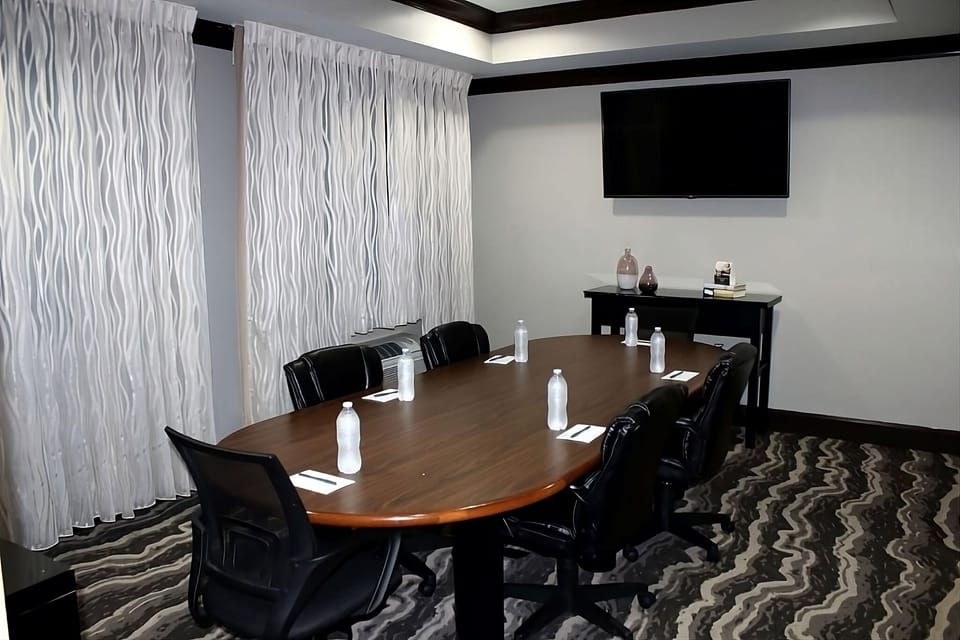 Host productive meetings around a polished table with big-screen.