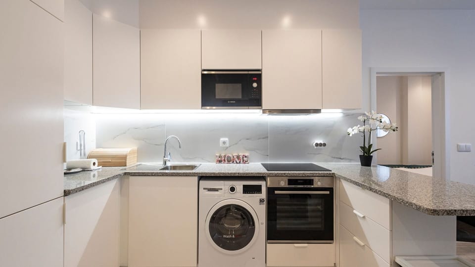 Effortless elegance awaits in our clean and white kitchenette. Experience the charm of simplicity and functionality in this bright culinary space. #CleanKitchen #Simplicity