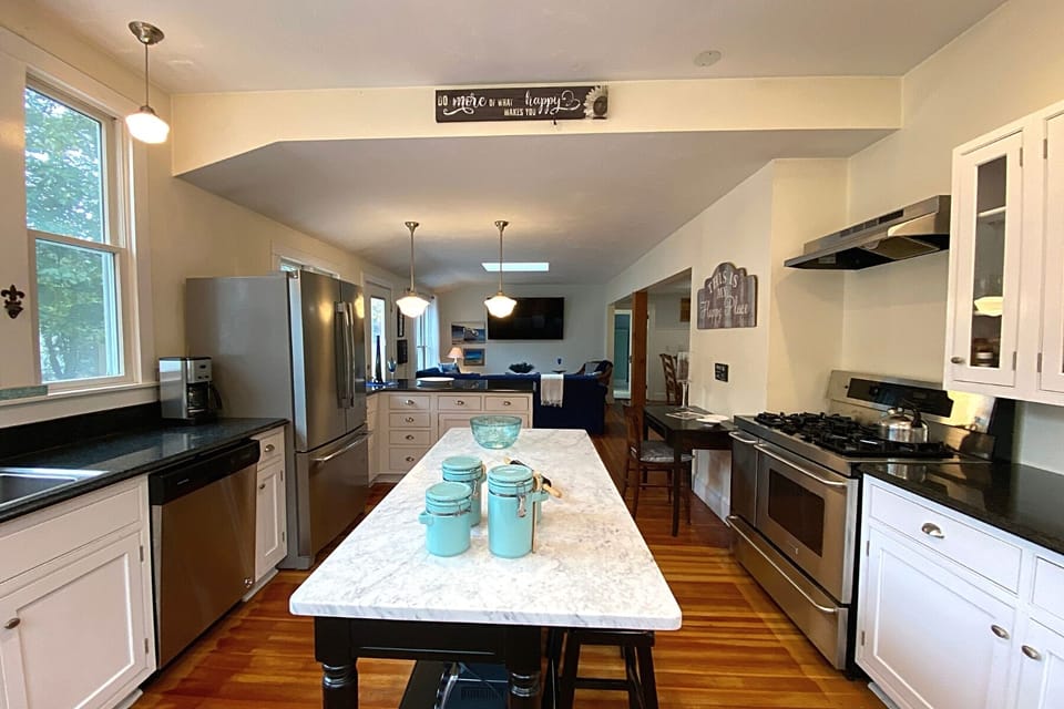 Fully equipped kitchen with granite countertops and modern appliances.