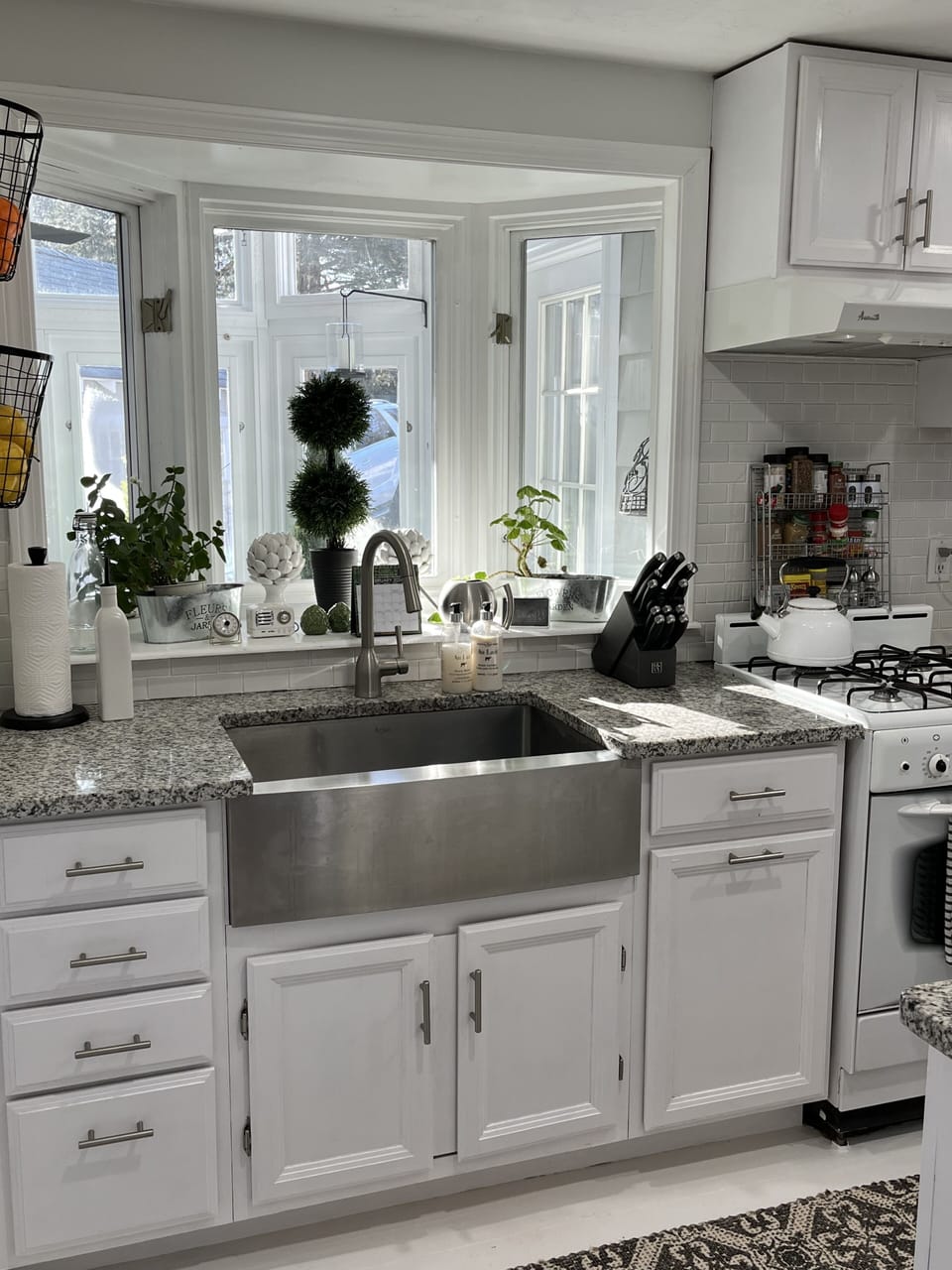 Kitchen with farmhouse sink and gas oven/stove.