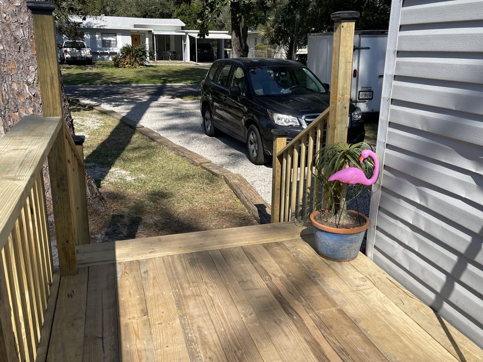 view out the deck looking at parking next to the house.