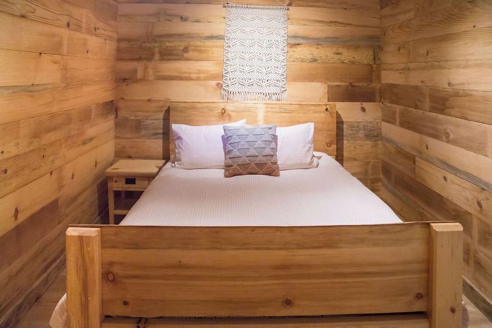 queen bed - walls lined with hand milled sugar pine from the land