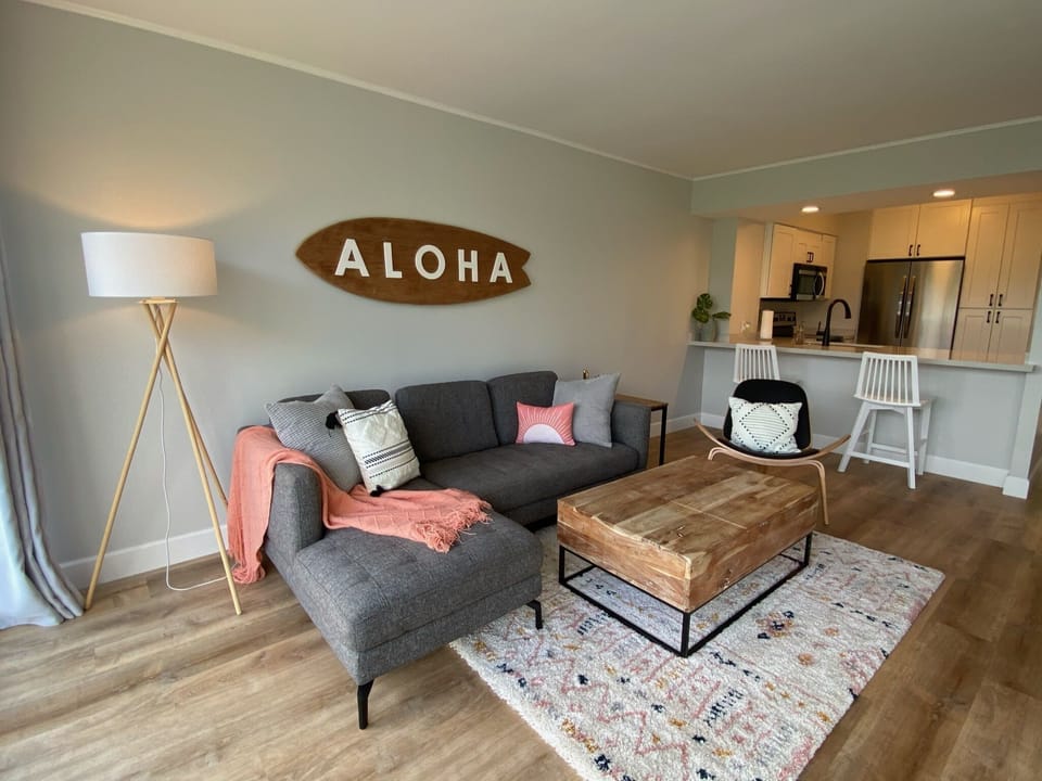 Spacious living room with views of the mountains and ocean. 