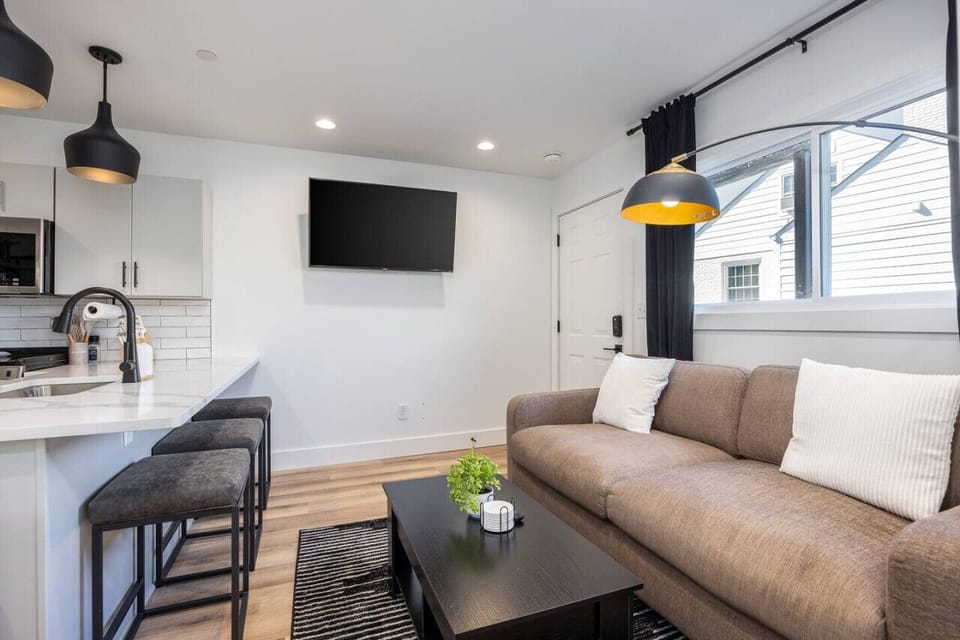 Cozy living room off the kitchen with a Smart TV, pull-out couch, and room-darkening shades. Tasteful decor & details provided for your comfort throughout the condo.