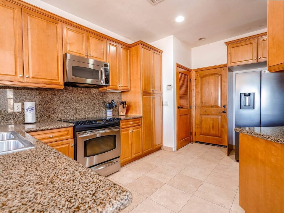 Fully equipped kitchen with refrigerator, oven, microwave, dishwasher, and coffee maker  — everything needed for home-cooked meals