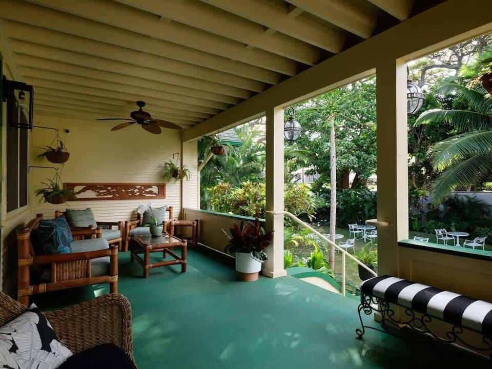 Porch living at its finest. Enjoy the island air & lush views in this relaxing outdoor space.