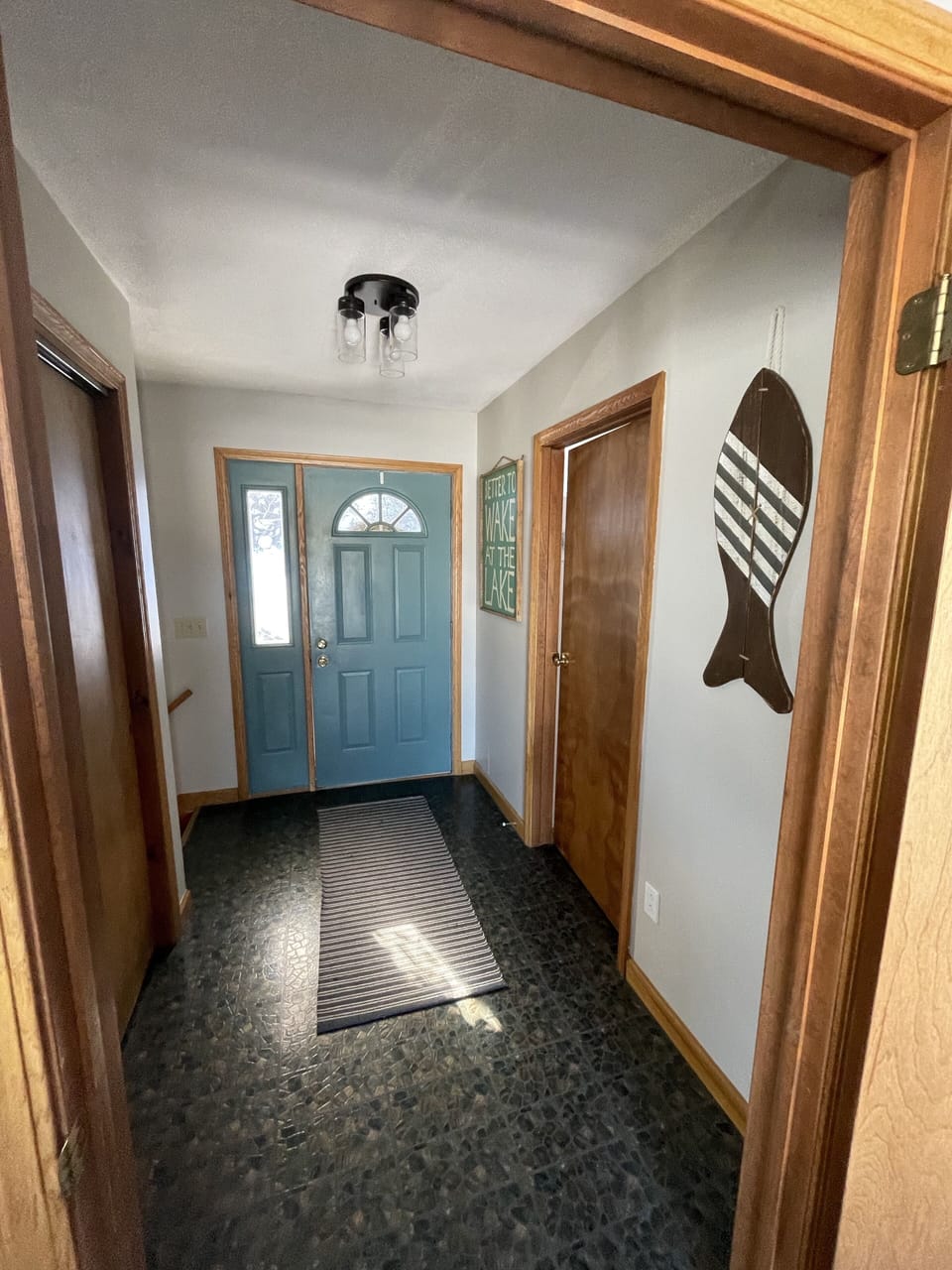 Street side entryway into hallway leading downstairs or into primary suite.