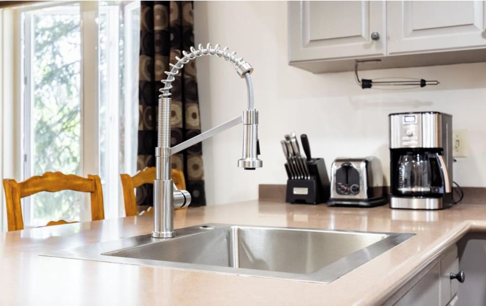 Modern fixtures, knife block, toaster, and coffee maker in the kitchen