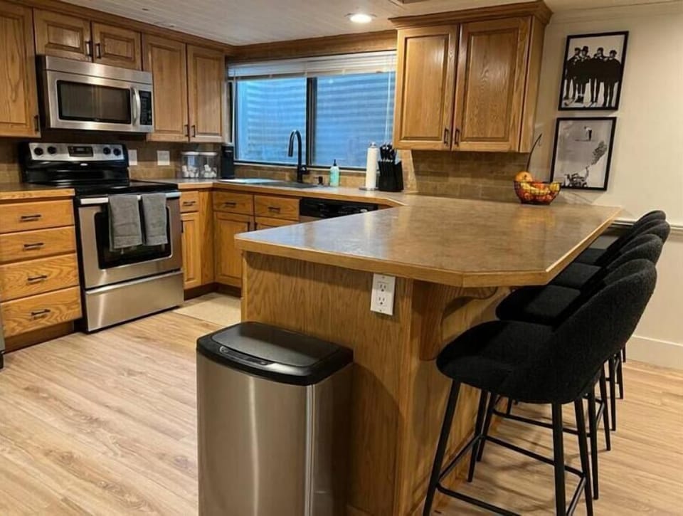 Full kitchen stocked with cookware, utensils, modern appliances, and coffee/tea