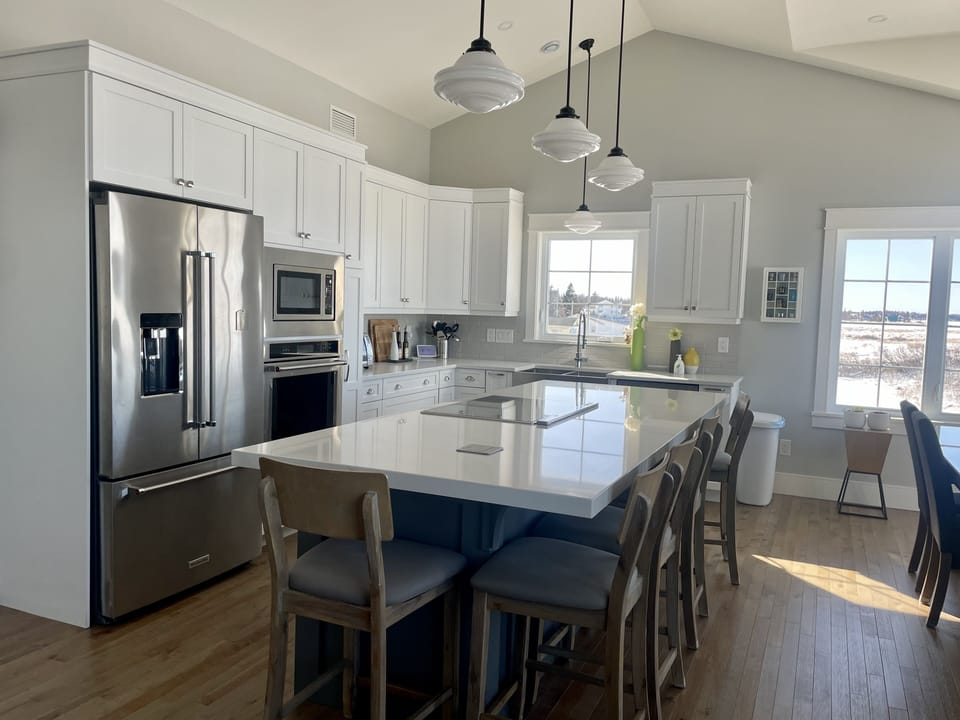 Open - living room, dining room and kitchen. Kitchen Aid appliances.