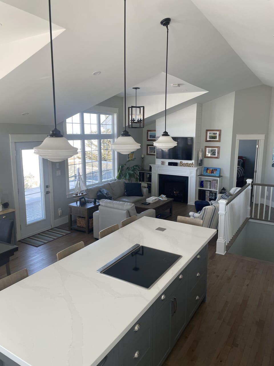 Open - living room, dining room and kitchen with 14' ceilings and wood floors.