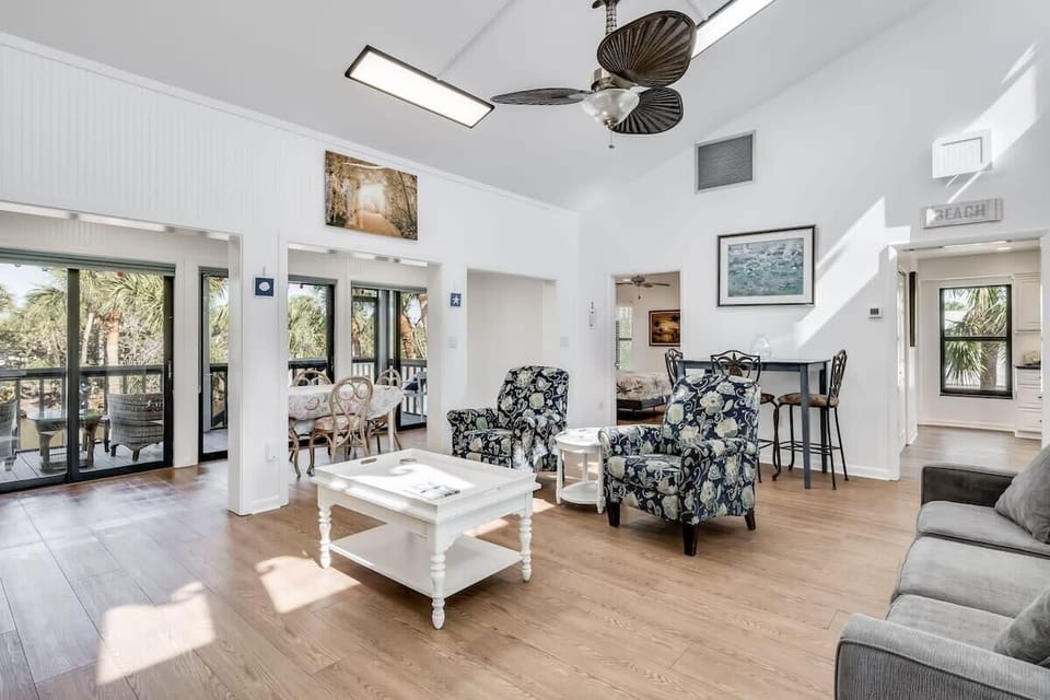 Gorgeous light filled living area with ample seating and flat screen TV