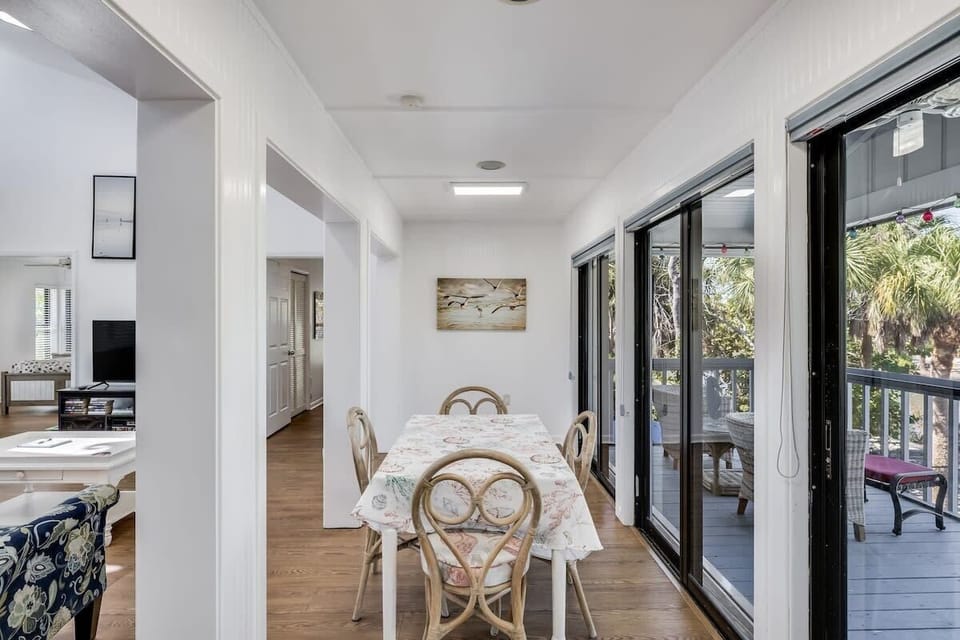 Dining area overlooking peaceful lagoon and pool behind home