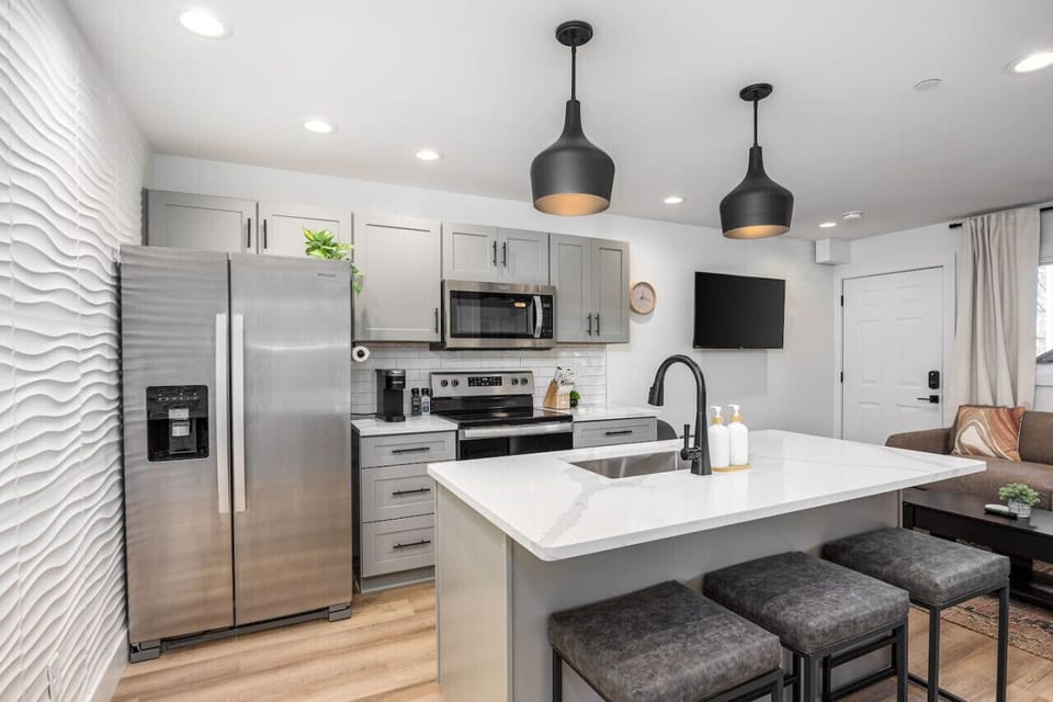 Fully-stocked modern kitchen with all the appliances and utensils you might need to enjoy a meal at home. Coffee provided for the Keurig and seating for 3 at the kitchen counter.
