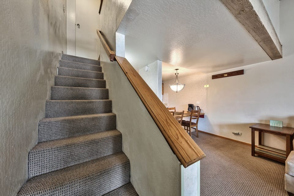 Your charming duplex features rustic exposed beams overhead and a cozy dining area perfect for intimate meals together.
