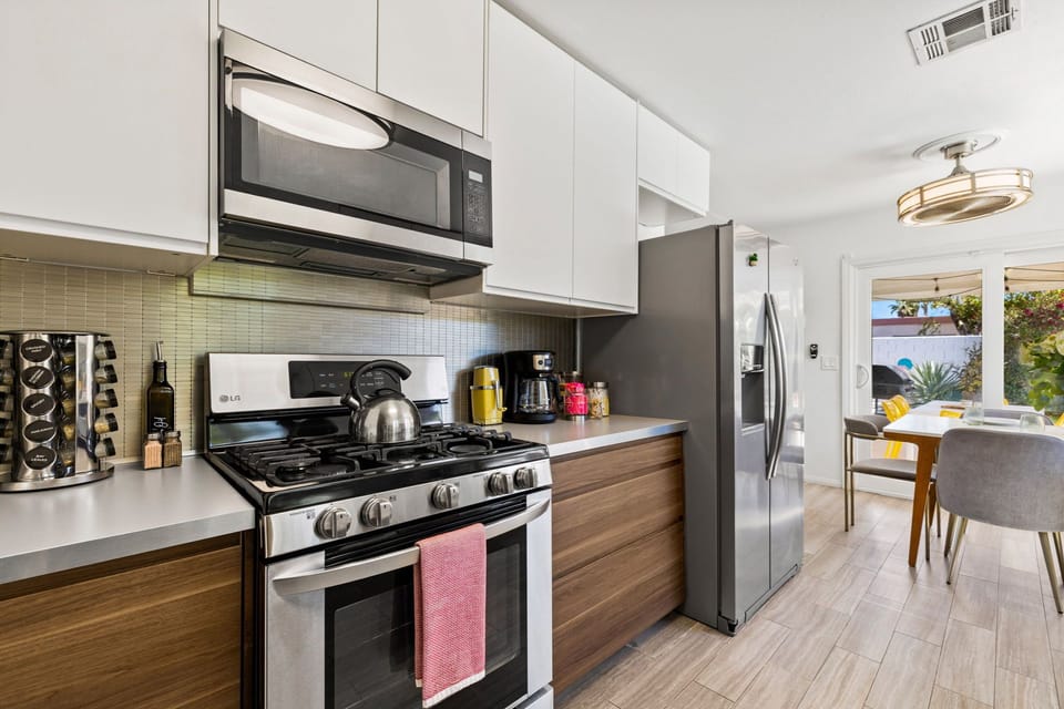 Fully equipped kitchen with sleek stainless steel appliances and all the cooking essentials for effortless meal prep.