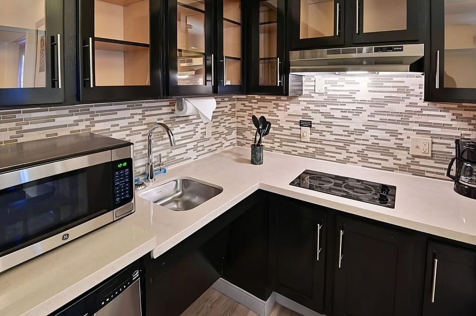 Brew coffee and prep snacks on sleek, modern counters.