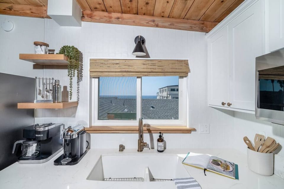 Fully stocked kitchen with pass through window to the deck outside
