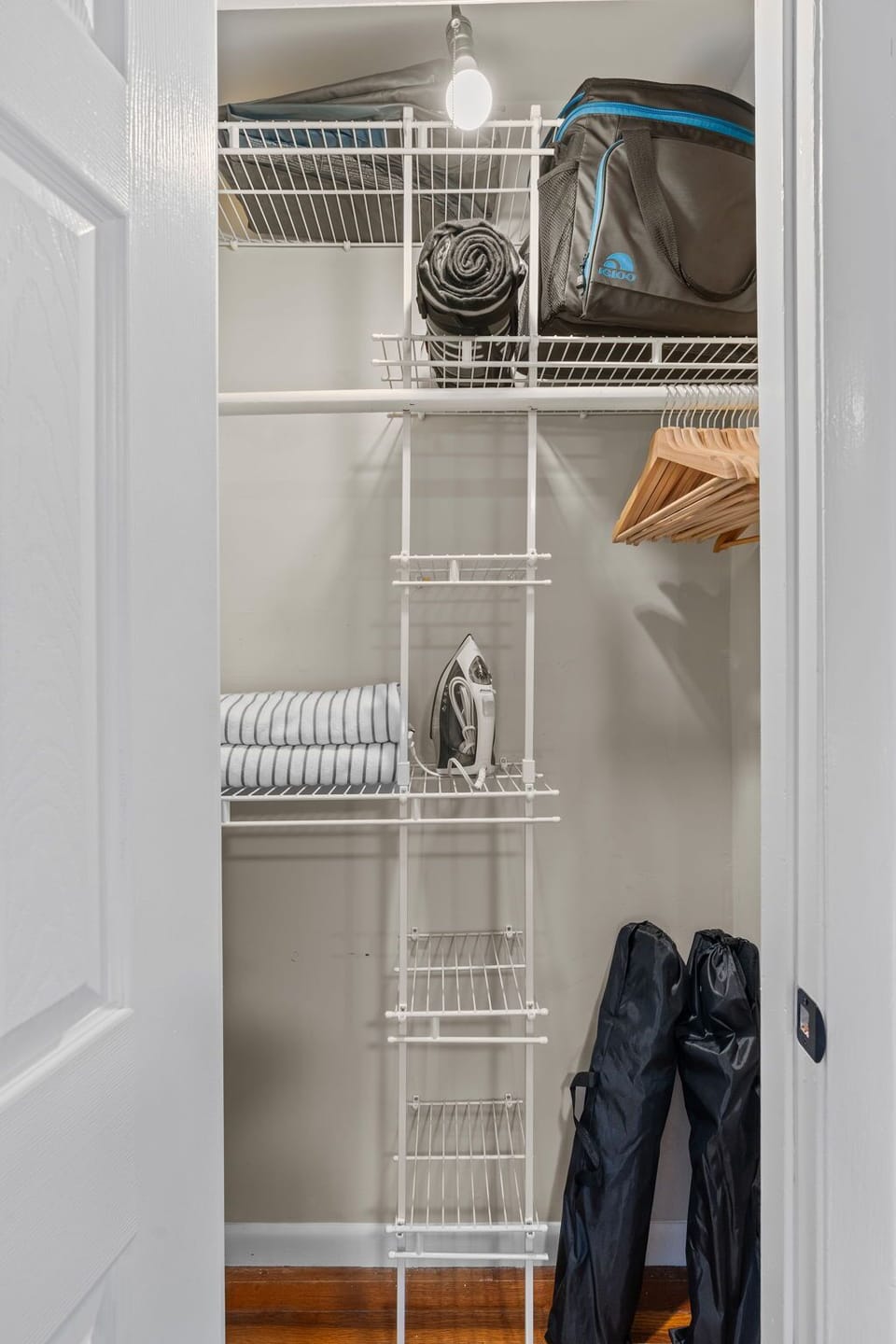 Convenient soft cooler, picnic blanket, chairs, iron and ironing board.