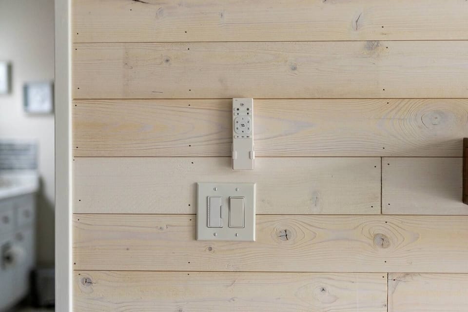 Primary bedroom controls for fireplace, overhead fan, and lighting.