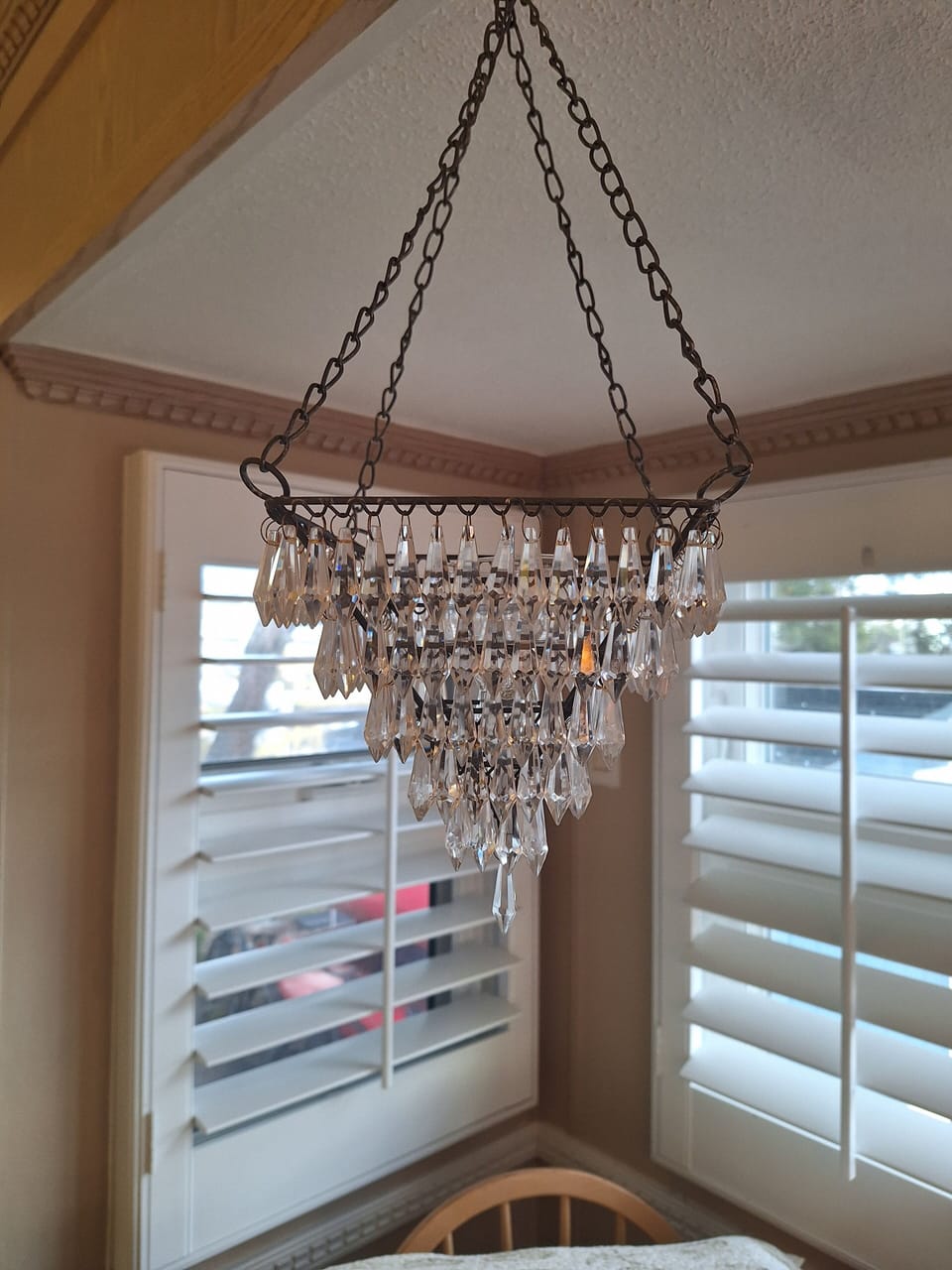 Miniature chandelier over kitchen table.