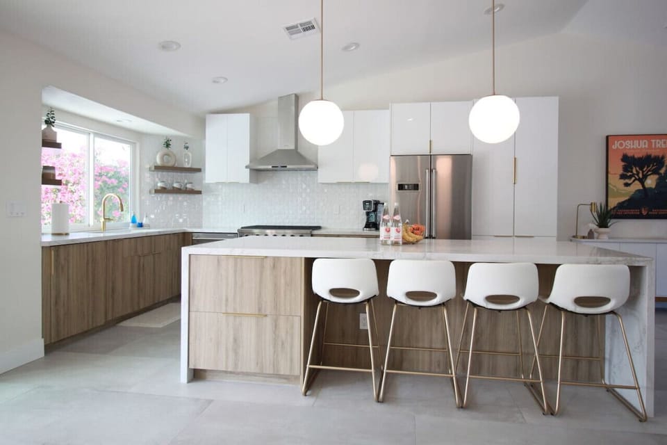 Spacious Kitchen with Oversized Island and Seating for Four. Dimmable Pendant Lights