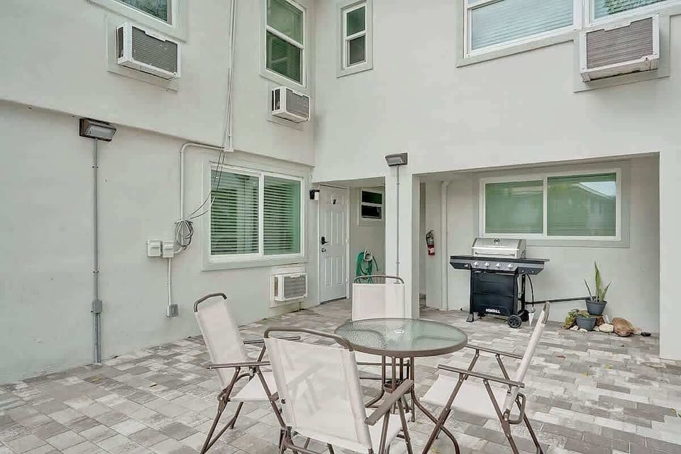 Shared courtyard patio with seating and BBQ grill