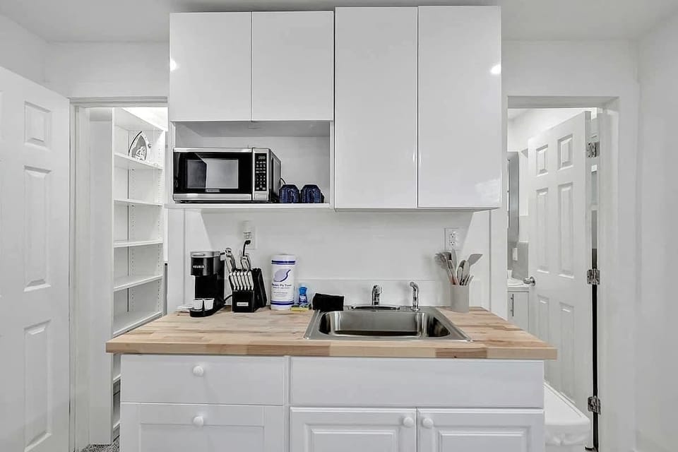 Kitchenette with butcher block counter and appliances