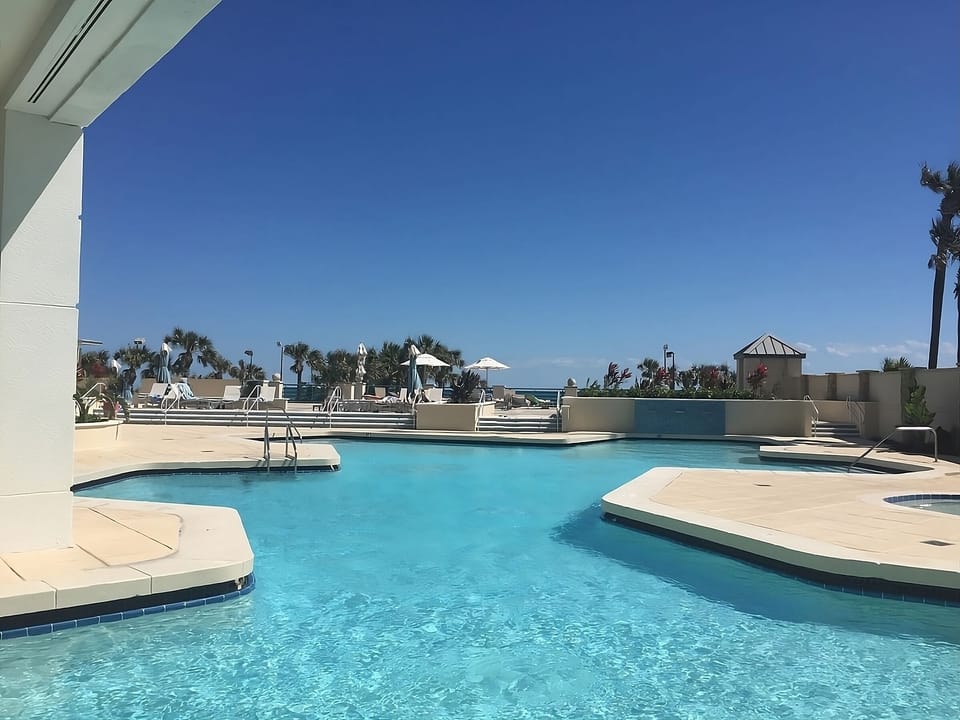 Dive into crystal-clear waters under a wide blue sky.