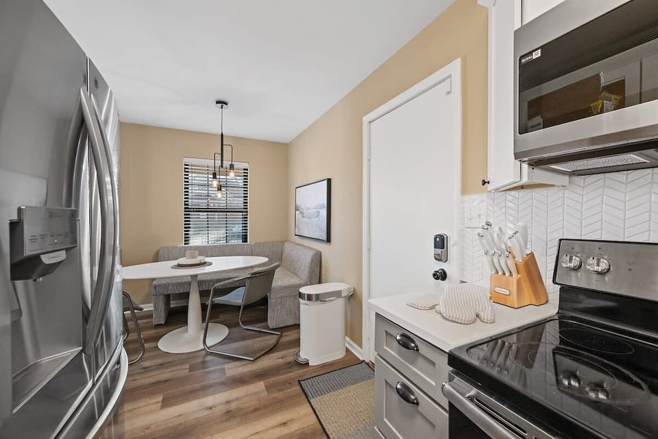 Elevate your culinary experience in this kitchen oasis adorned with shiny stainless steel appliances. Pull up a chair at the dining table and savor every bite in style. #KitchenGoals #DiningInStyle #HomeInspo 