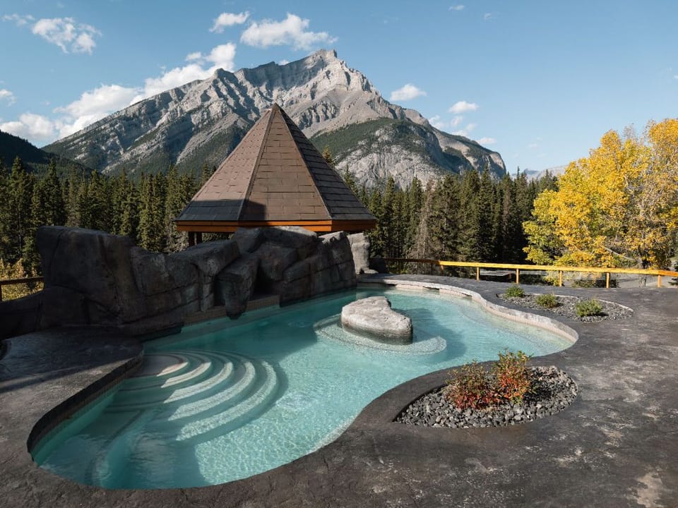A rooftop oasis with a serene pool, framed by stunning mountain vistas and crisp, fresh air.