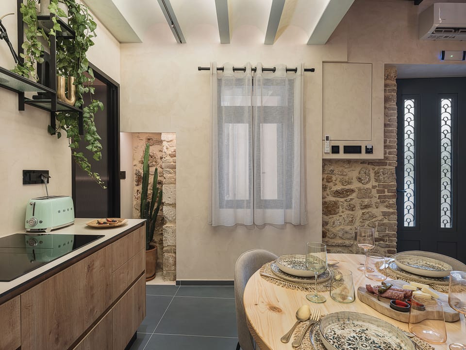 Bright kitchen and dining area with stone accents, natural textures, and warmth