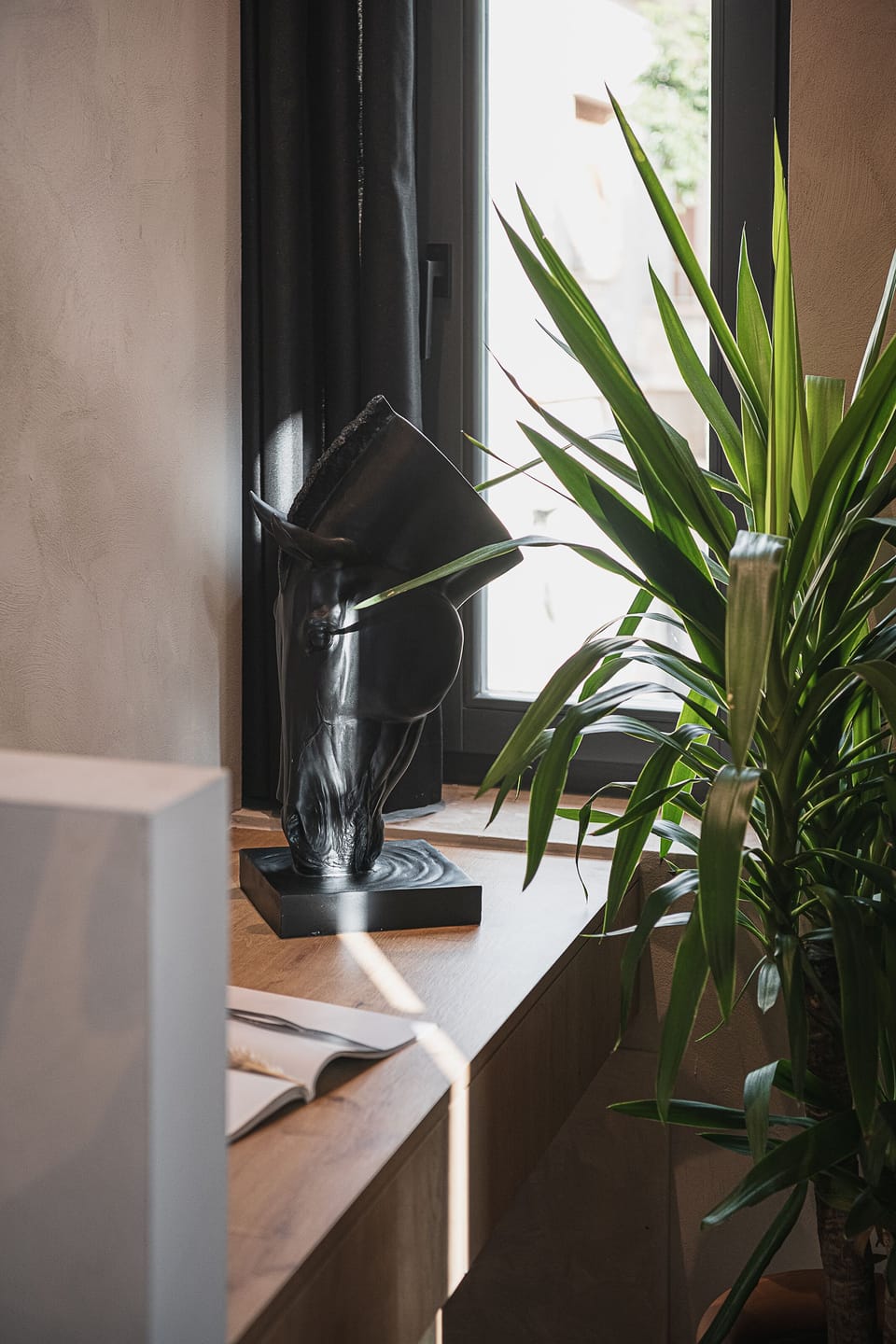 Stylish desk corner with décor and greenery, perfect for reading or light work