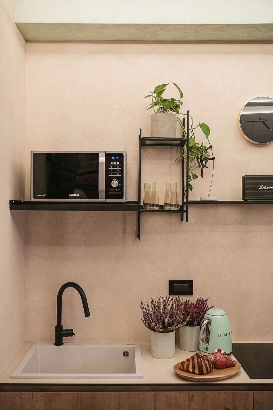 Kitchenette with microwave, sink, and essentials for light meals and coffee.